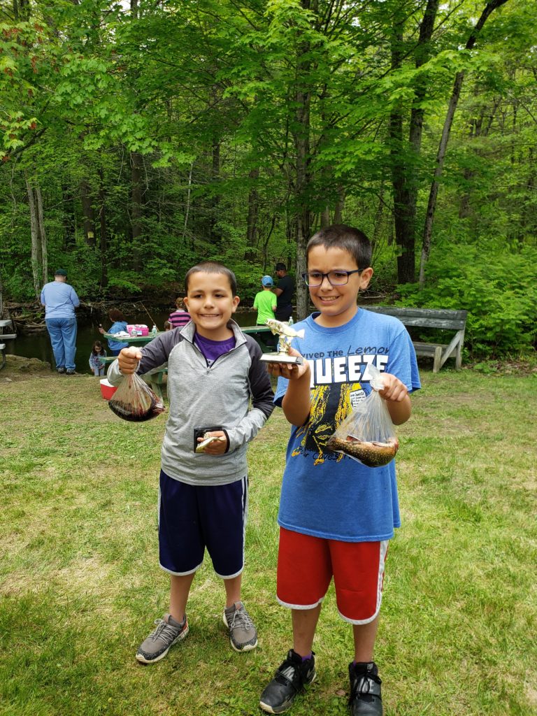 JD and Wyatt holding trophies.